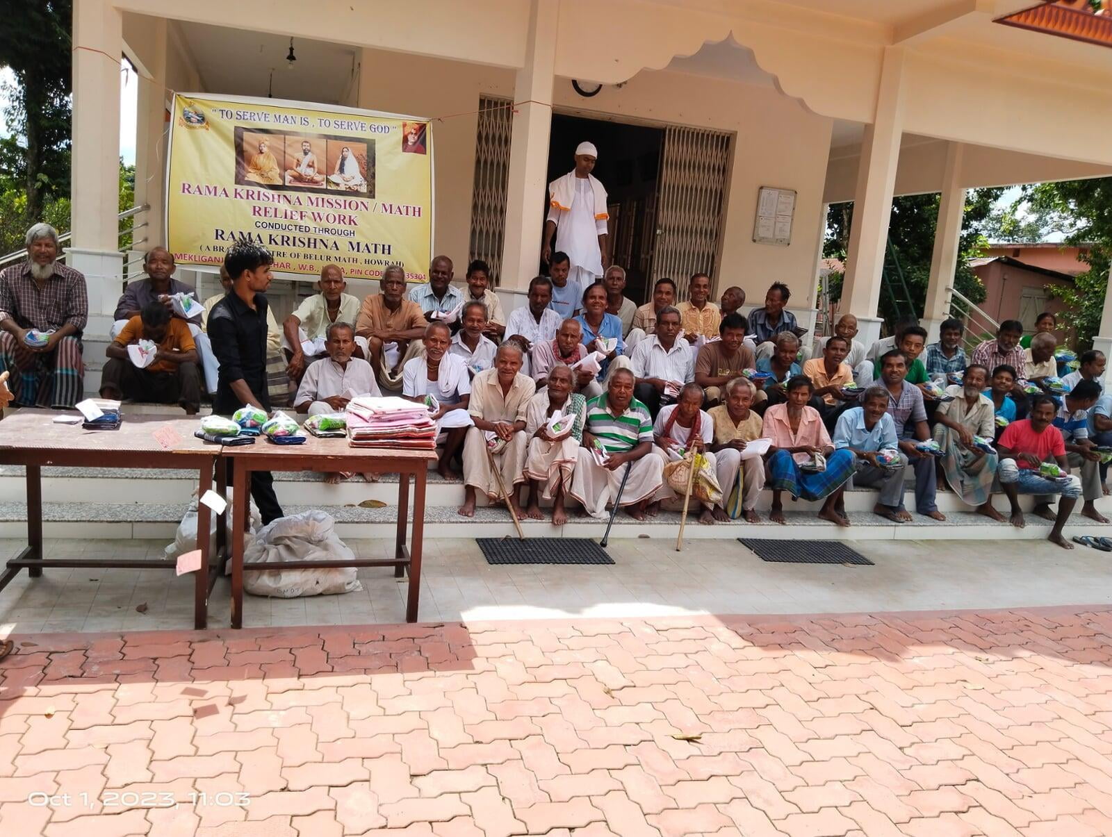 Distribution of Saree, Dhoti, Lungi, and Tiffin packets among poor and needy people